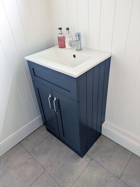 Cloakroom sink with decorative wall panelling